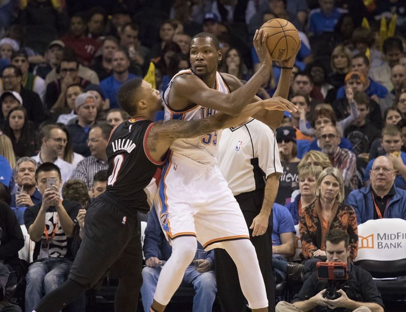 Kevin Durant (right) is guarded by Damian Lillard (left)
