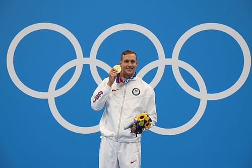 Caeleb Dressel with one of his five gold medals