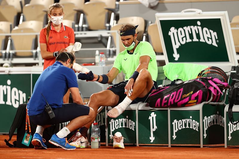Rafael Nadal receives medical attention during the Roland Garros 2021 semifinal against Novak Djokovic