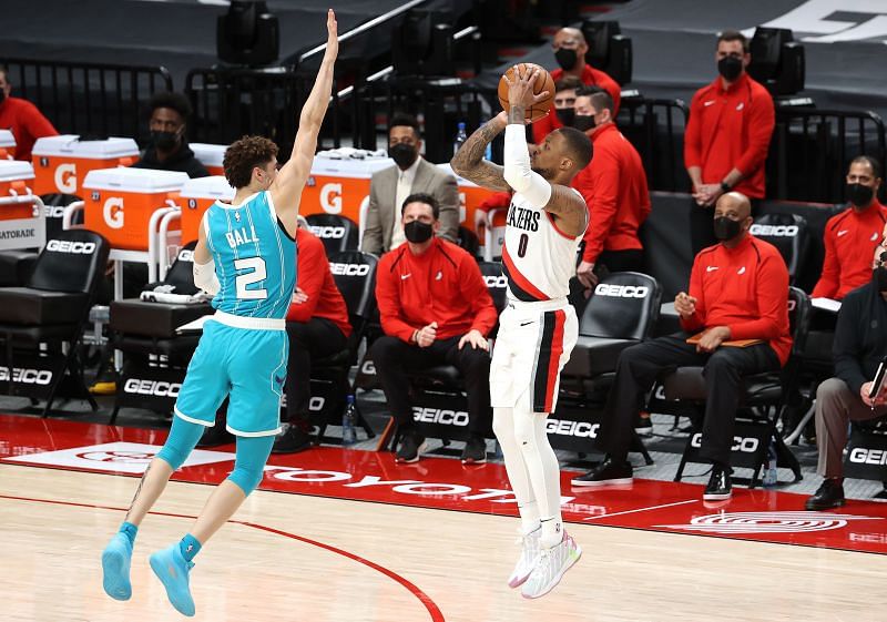 Damian Lillard #0 of the Portland Trail Blazers takes a shot against LaMelo Ball #2 of the Charlotte Hornets