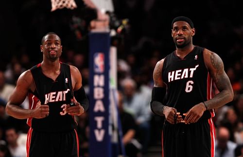 Dwyane Wade (#3) and LeBron James (#6) look on before a game against the Knicks.