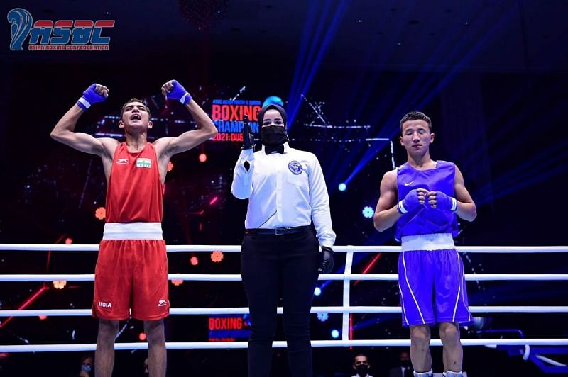 Rohit Chamoli (in red) celebrates after winning the gold medal at the Asian Junior Championships.