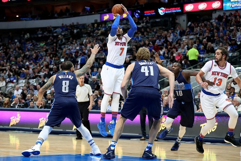 Carmelo Anthony (#7) shoots the ball against Deron Williams (#8).