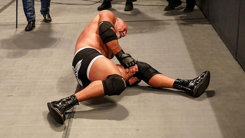 Goldberg tending to his leg at SummerSlam 2021