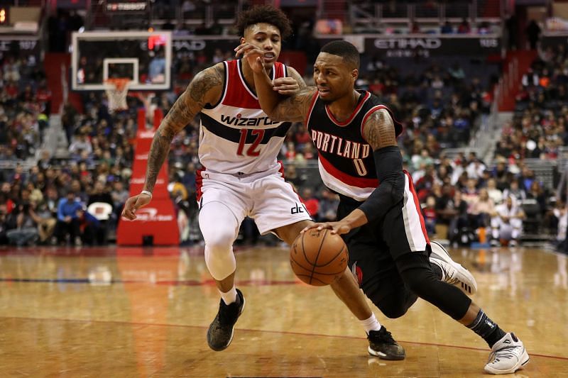 Damian Lillard of the Portland Trail Blazers battles Kelly Oubre Jr. when of the Washington Wizards