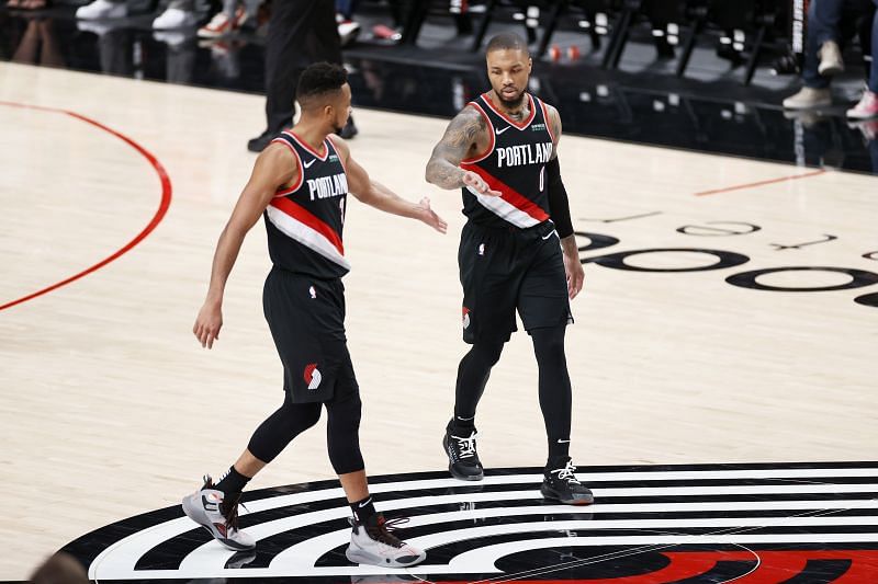Damian Lillard (#0) and CJ McCollum (#3) acknowledge each other on the court.