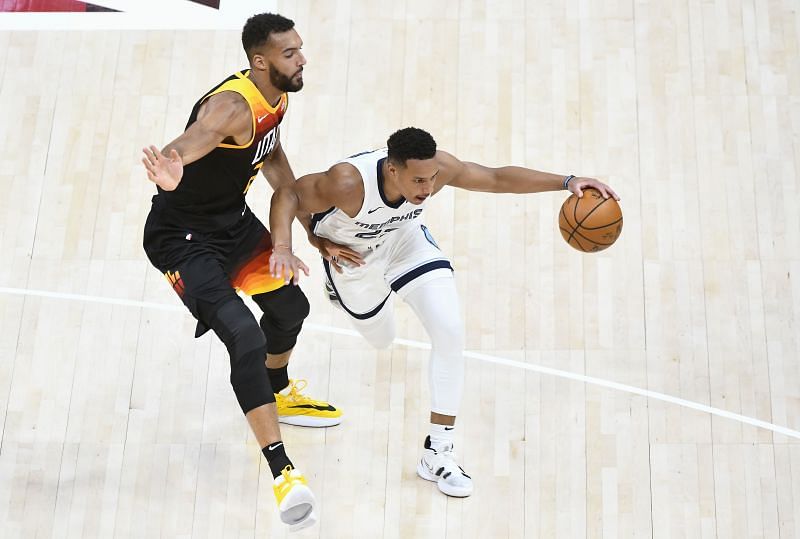 Desmond Bane (right) drives past Rudy Gobert (left)