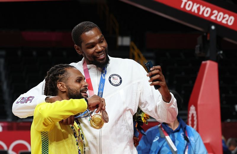 Brooklyn Nets teammates Kevin Durant (right) and Patty Mills celebrate at the Tokyo Olympics.