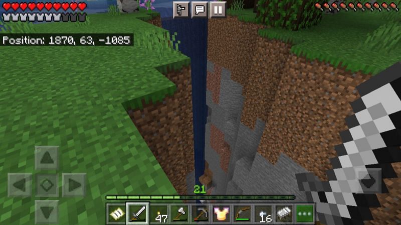 Waterfall going from the top of a ravine to the bottom (Image via Minecraft)