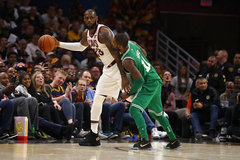 LeBron James #23 of the Cleveland Cavaliers looks to get around Kyrie Irving #11 of the Boston Celtics
