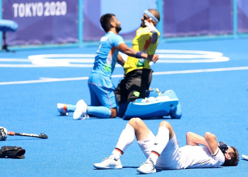 PR Sreejesh of celebrates with Indian captain Manpreet Singh after winning while Lukas Windfeder of Germany reacts following the Men&#039;s Bronze medal match between Germany and India