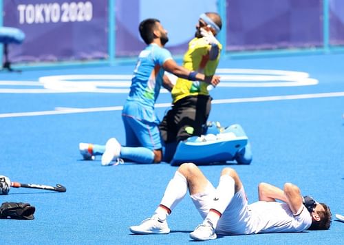 PR Sreejesh of celebrates with Indian captain Manpreet Singh after winning while Lukas Windfeder of Germany reacts following the Men's Bronze medal match between Germany and India