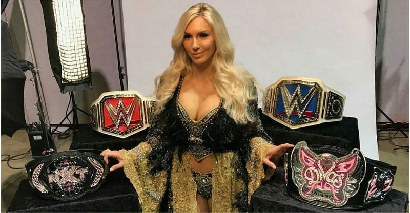 Charlotte Flair posing all of her singles Women&#039;s Championships