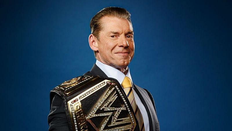 Vince McMahon holding one of the modern versions of the WWE Championship