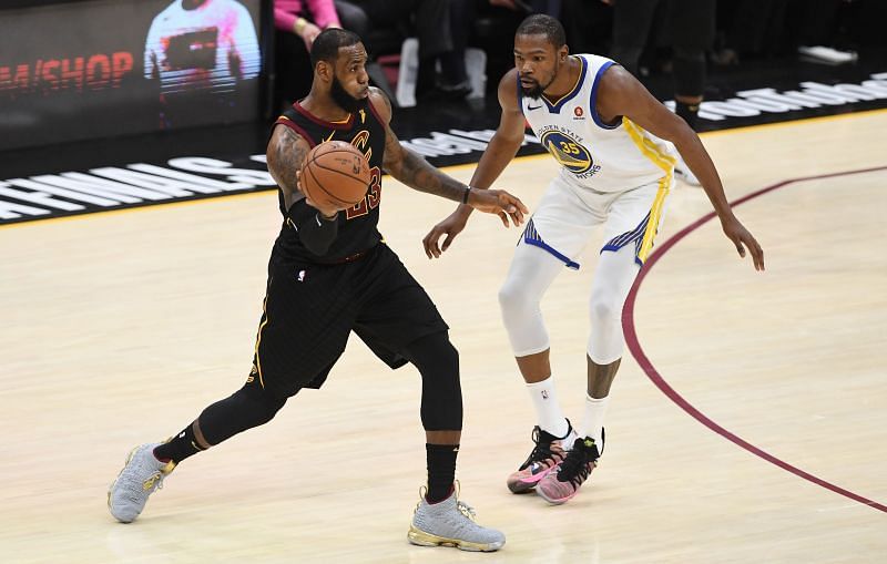 LeBron James #23 controls the ball against Kevin Durant #35.