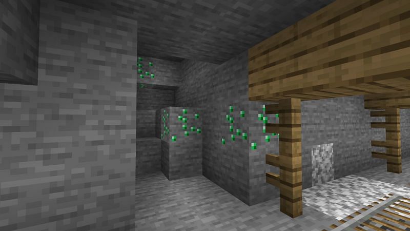 Emerald ores in a mineshaft (Image via Minecraft)