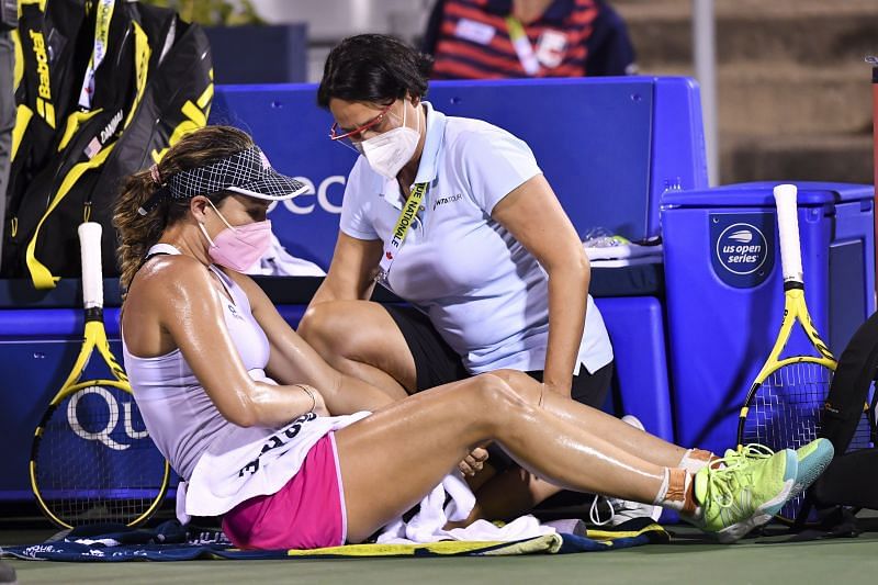 Danielle Collins receives medical attention during the third set of her match against Simona Halep