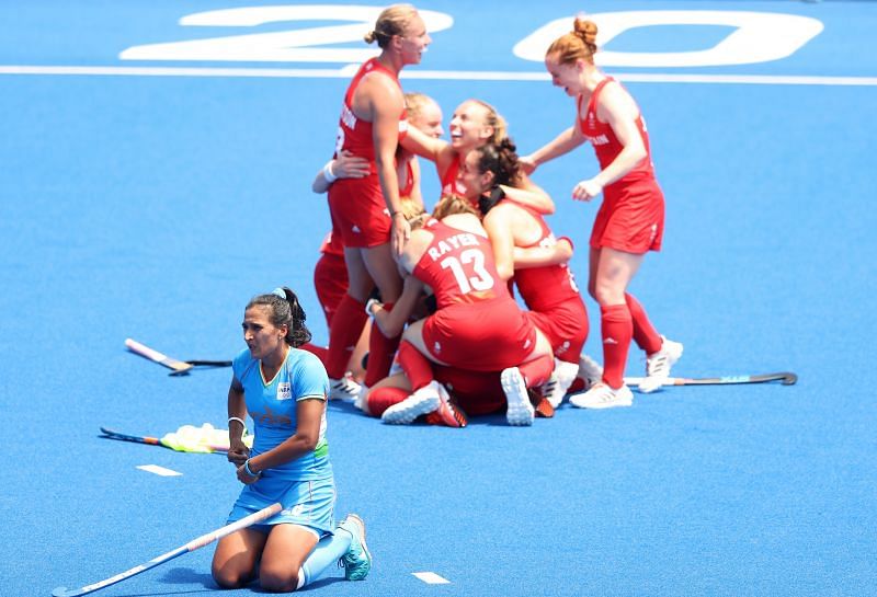 India captain Rani Rampal looks distaught as Great Britain celebrate winning the bronze medal