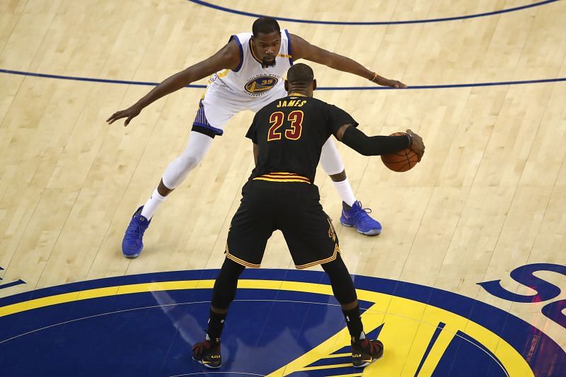 LeBron James #23 is defended by Kevin Durant #35.