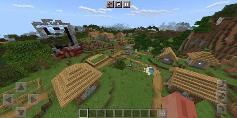 A village with a ruined portal (Image via Minecraft)