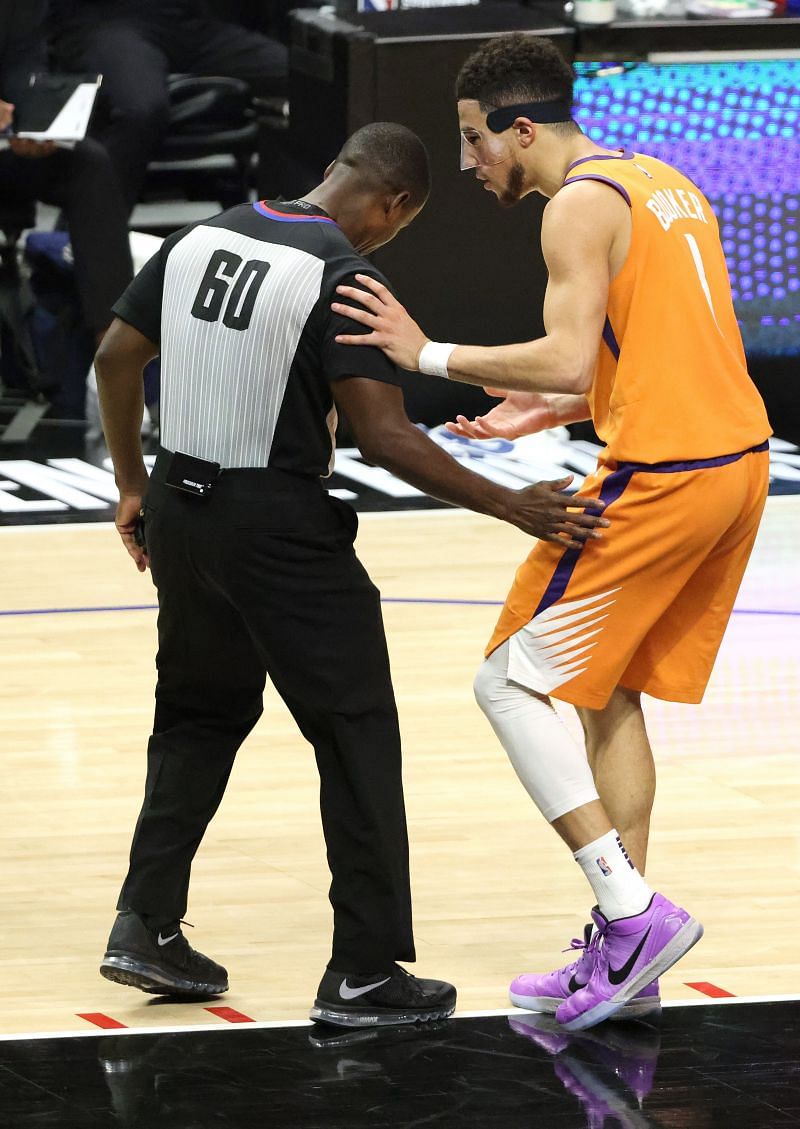 Devin Booker (#1) of the Phoenix Suns argues a call with referee James Williams (#60)