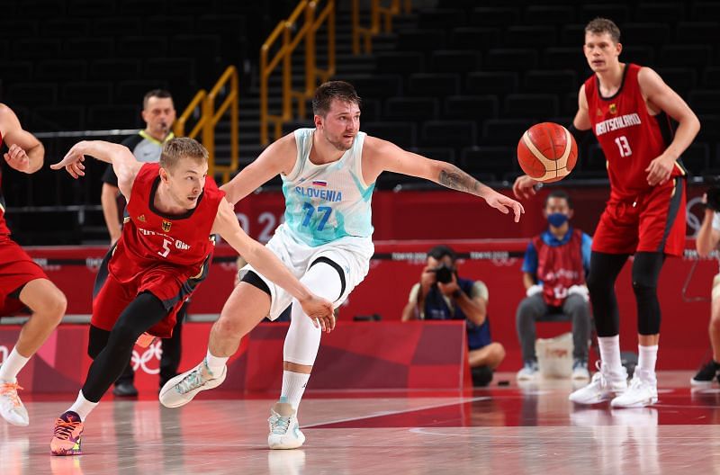 Niels Giffey #5 and Luka Doncic #77 reach for a loose ball.