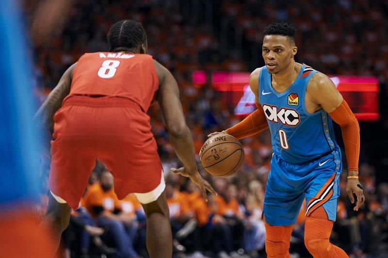 Russell Westbrook (#0) brings the ball up court against Al-Farouq Aminu (#8).