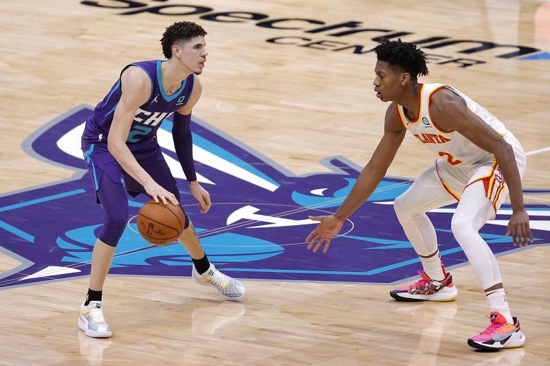 LaMelo Ball #2 of the Charlotte Hornets brings the ball up court against De&#039;Andre Hunter #12 of the Atlanta Hawks