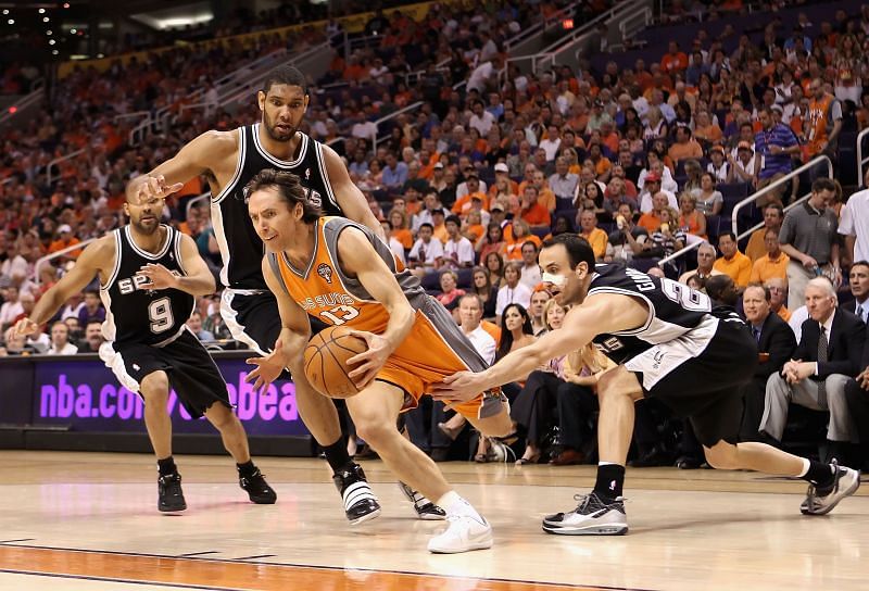 Steve Nash dribbles to the paint as the Spurs Big 3 try to stop him