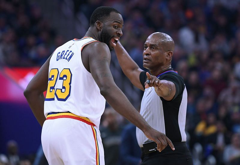 Draymond Green (#23) of the Golden State Warriors complains to referee Derrick Collins (#11) after being called for a foul.