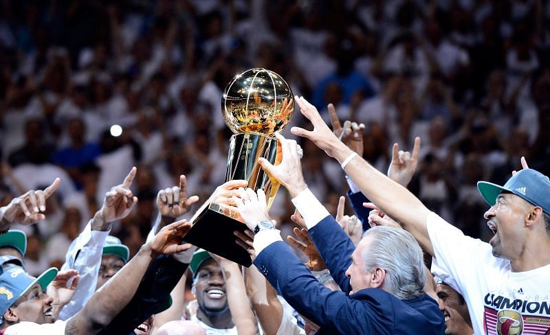 Team President Pat Riley and the Miami Heat players celebrate with the Larry O&#039;Brien Championship trophy.