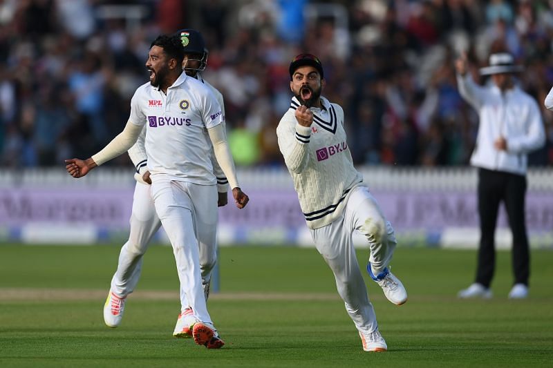 Bowler Mohammed Siraj and captain Virat Kohli of India celebrate