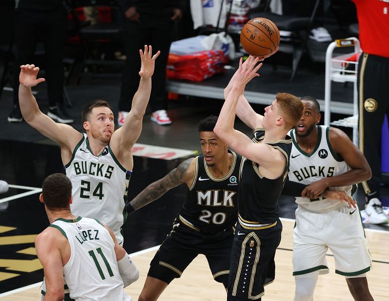 Kevin Huerter #3 of the Atlanta Hawks shoots against Pat Connaughton #24 of the Milwaukee Bucks during the second half in Game Four of the Eastern Conference Finals at State Farm Arena on June 29, 2021 in Atlanta, Georgia.