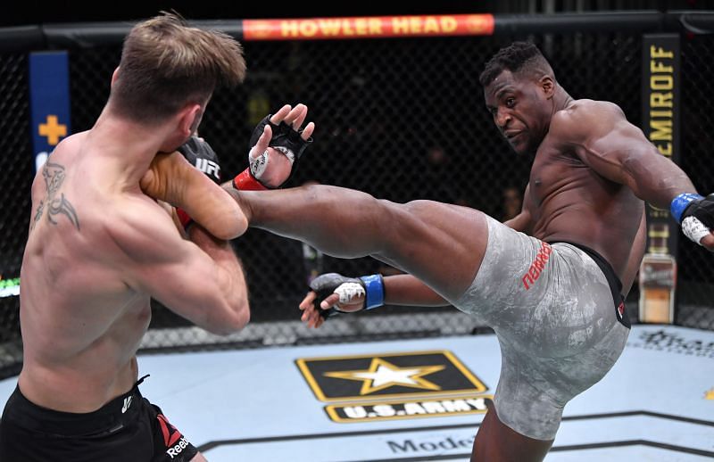 Francis Ngannou lands a high kick on Stipe Miocic. 