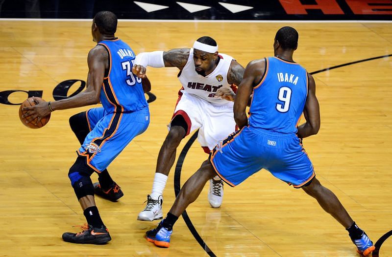 Kevin Durant #35 of the Oklahoma City Thunder attempts to drive around a pick set by teammates Serge Ibaka #9 against LeBron James #6 of the Miami Heat