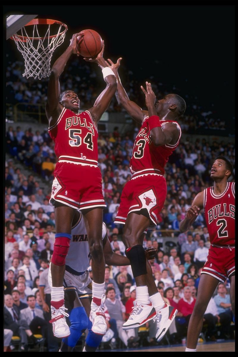 Two Chicago Bulls player go up for a rebound.