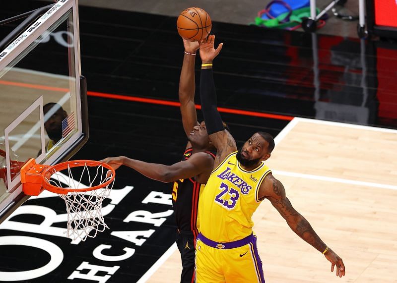 LeBron James #23 of the Los Angeles Lakers defends a pass intended for Clint Capela #15 of the Atlanta Hawks during the first half at State Farm Arena on February 01, 2021 in Atlanta, Georgia.