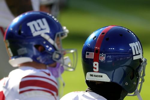 Punter Riley Dixon #9 of the New York Giants wears a "End Racism" sticker on the back of his helmet