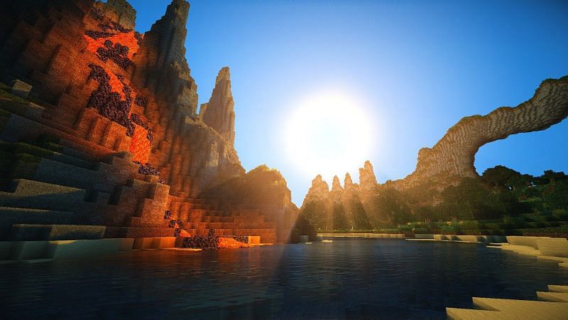 An image of lava flowing down a Minecraft mountain and into a river. (Image via Minecraft)