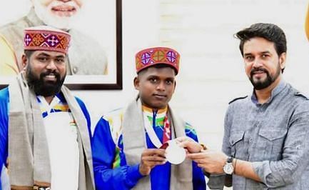 Sports Minister Anurag Thakur felicitates Paralympics silver medallist Mariyappan Thangavelu.