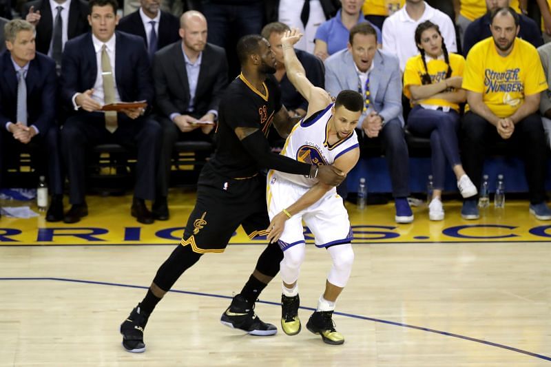 LeBron James #23 of the Cleveland Cavaliers defends Stephen Curry #30 of the Golden State Warriors