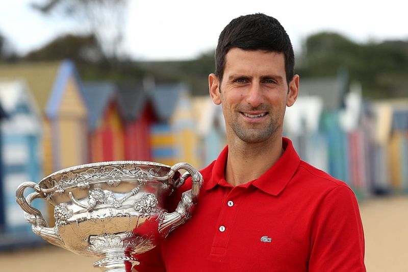 Novak Djokovic poses with the 2021 Australian Open title during Media Day