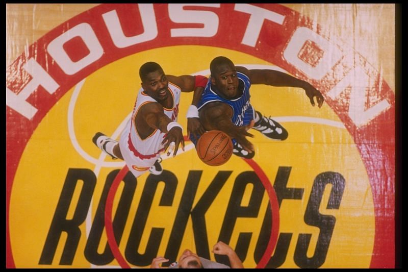 Center Hakeem Olajuwon of the Houston Rockets and Orlando Magic center Shaquille O''Neal go up for the ball during a Finals game