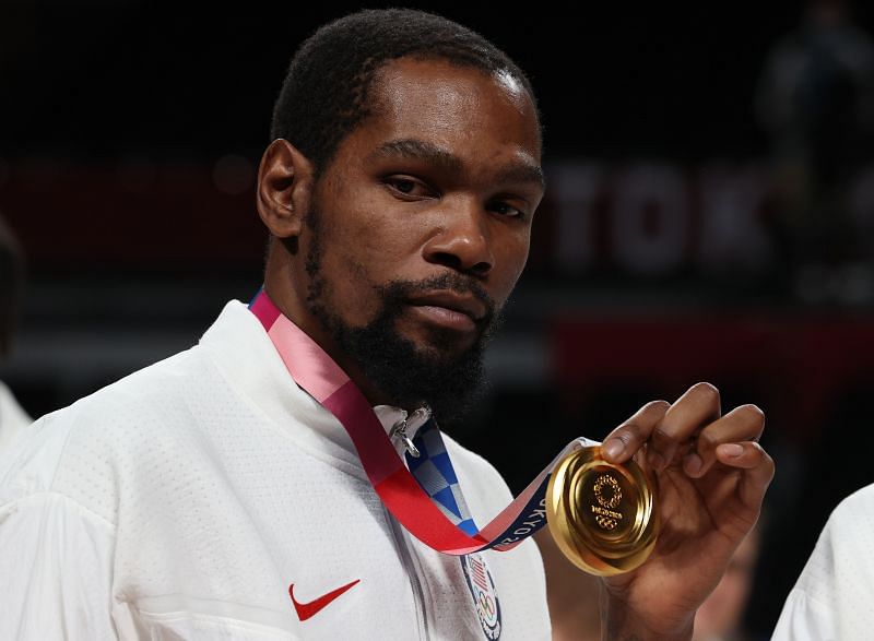 Kevin Durant of Team United States poses for photographs with his Olympic gold medal.