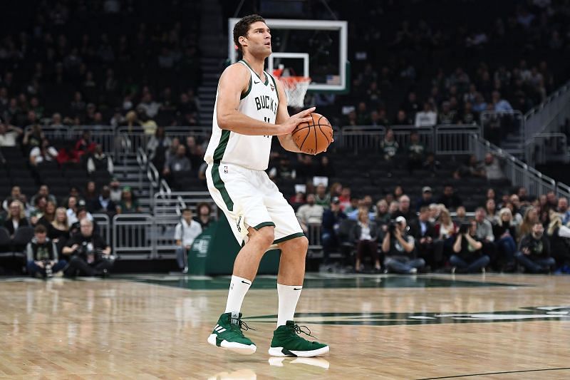 Brook Lopez takes a three-point shot during a game