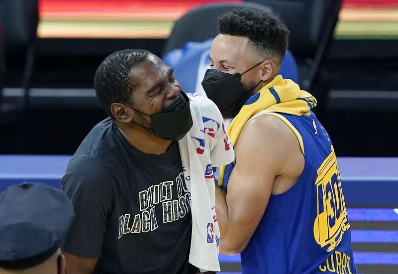Kevin Durant #7 of the Brooklyn Nets and Stephen Curry #30 of the Golden State Warriors together laughing after the Nets defeated the Warriors 134-117 in an NBA basketball game at Chase Center on February 13, 2021 in San Francisco, California.