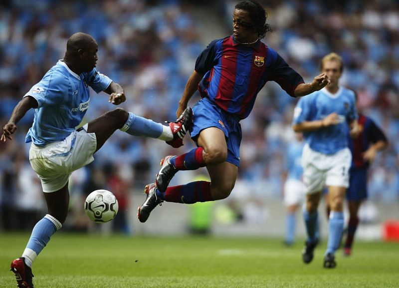 Ronaldinho of FC Barcelona and David Sommeil of Manchester City