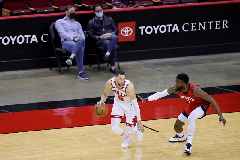 Zach LaVine #8 of the Chicago Bulls controls the ball ahead of David Nwaba #2 of the Houston Rockets during the second quarter of a game at the Toyota Center on February 22, 2021 in Houston, Texas.