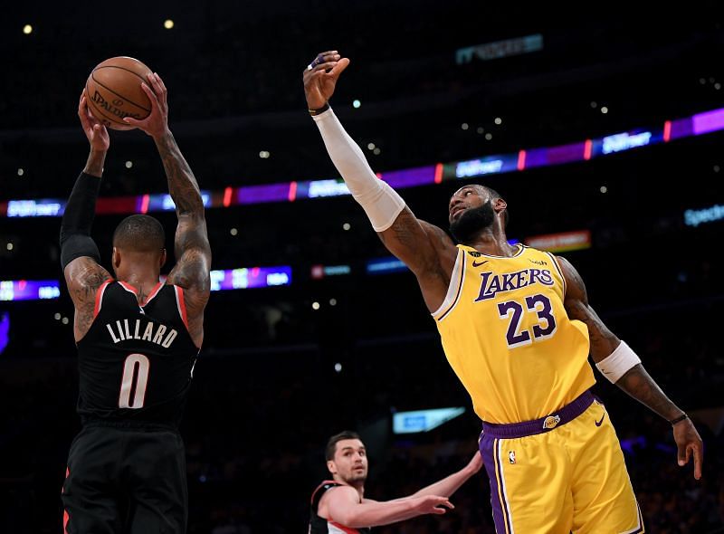 Damian Lillard (left) and LeBron James in action during an NBA game.