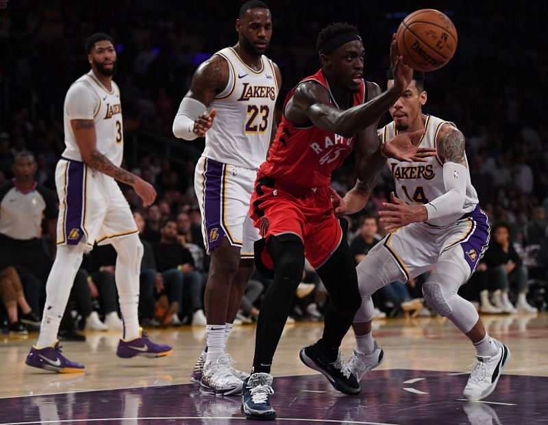 Pascal Siakam #43 of the Toronto Raptors passes in front of Danny Green #14, LeBron James #23